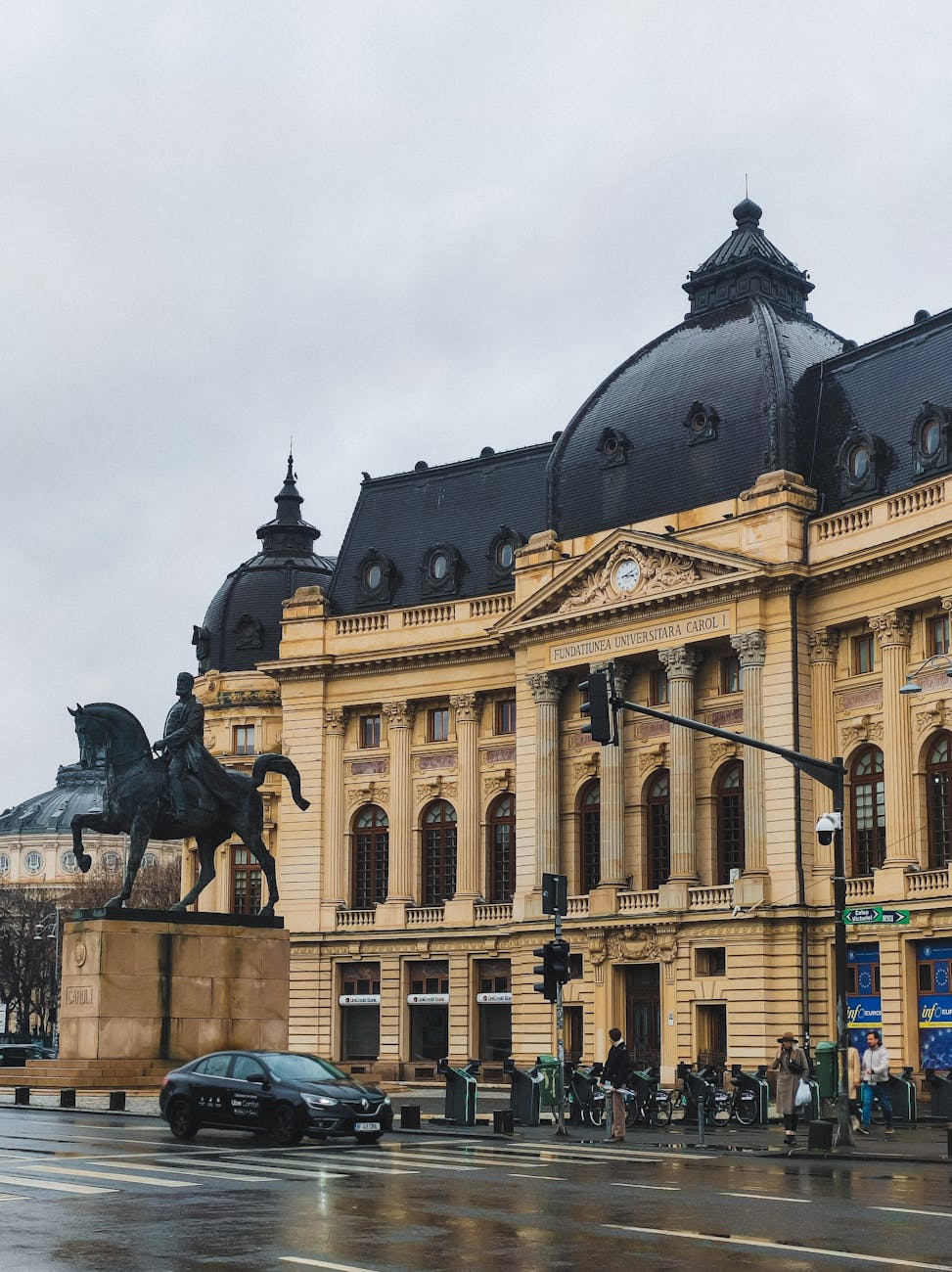 historic building and equestrian statue in bucharest