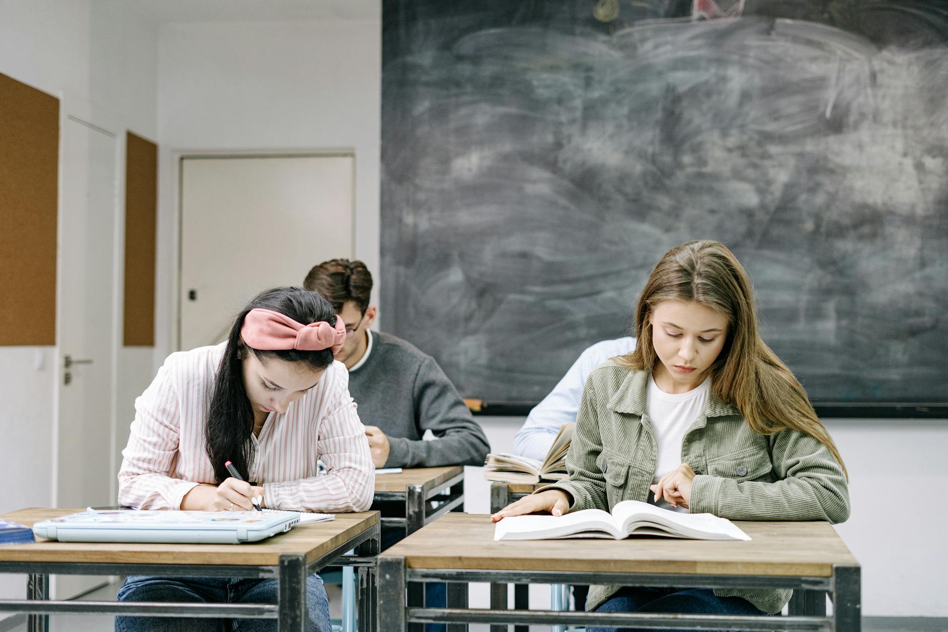 students sitting by the table in the classroom