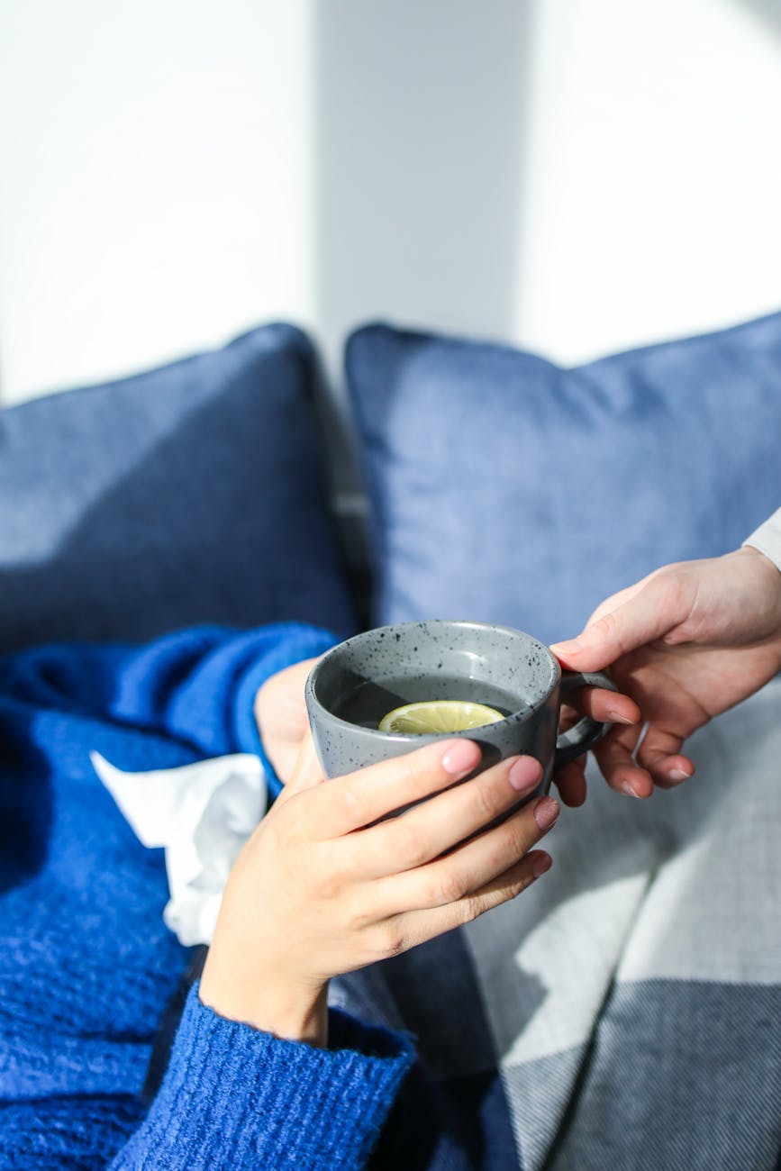 person holding gray ceramic mug